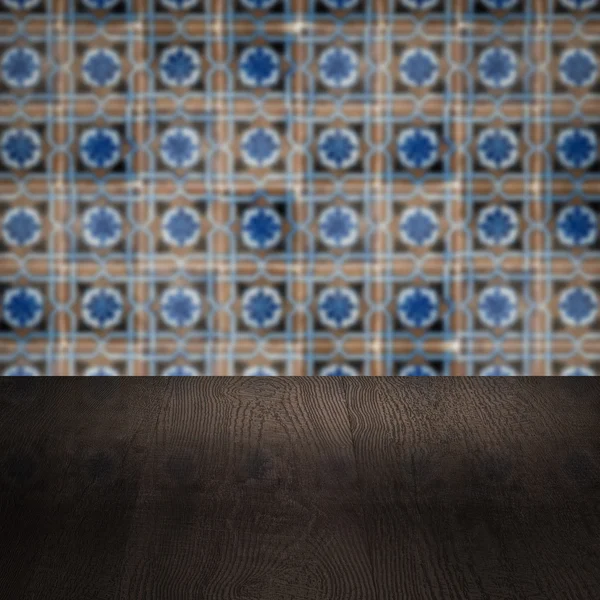 Wood table top and blur vintage ceramic tile pattern wall — Stock Photo, Image