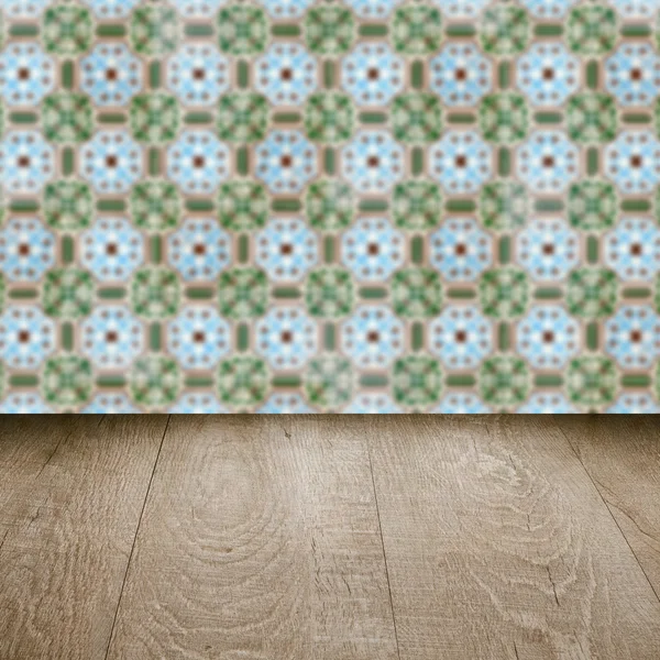 Wood table top and blur vintage ceramic tile pattern wall — Stock Photo, Image