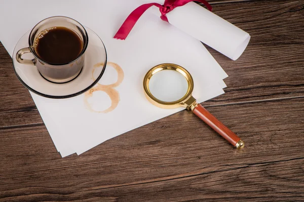 Coffee cup, paper sheets and detective hat — Stock Photo, Image