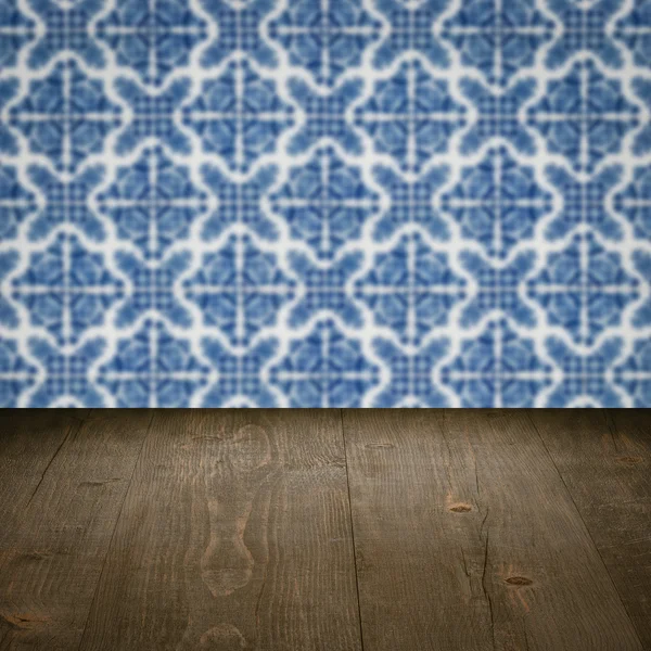 Wood table top and blur vintage ceramic tile pattern wall — Stock Photo, Image