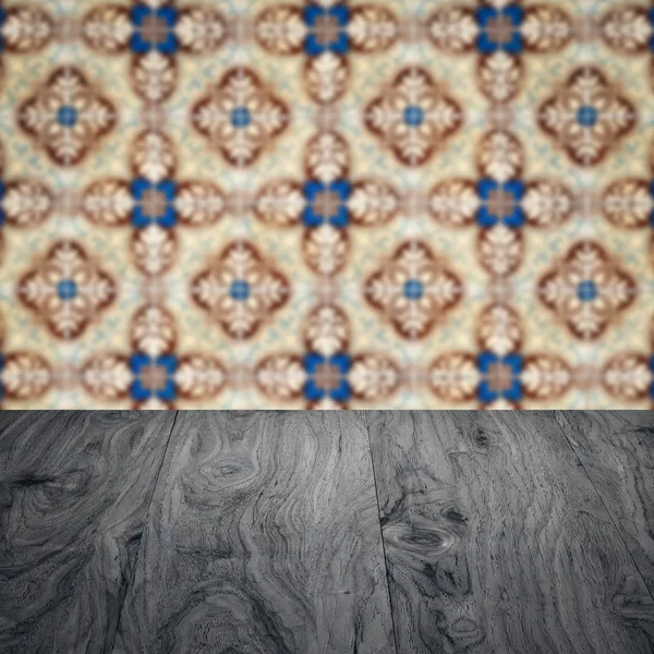 Wood table top and blur vintage ceramic tile pattern wall — Stock Photo, Image