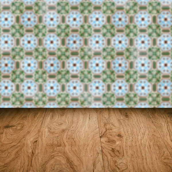 Wood table top and blur vintage ceramic tile pattern wall — Stock Photo, Image