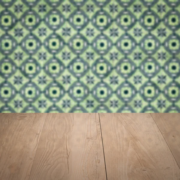 Wood table top and blur vintage ceramic tile pattern wall — Stock Photo, Image