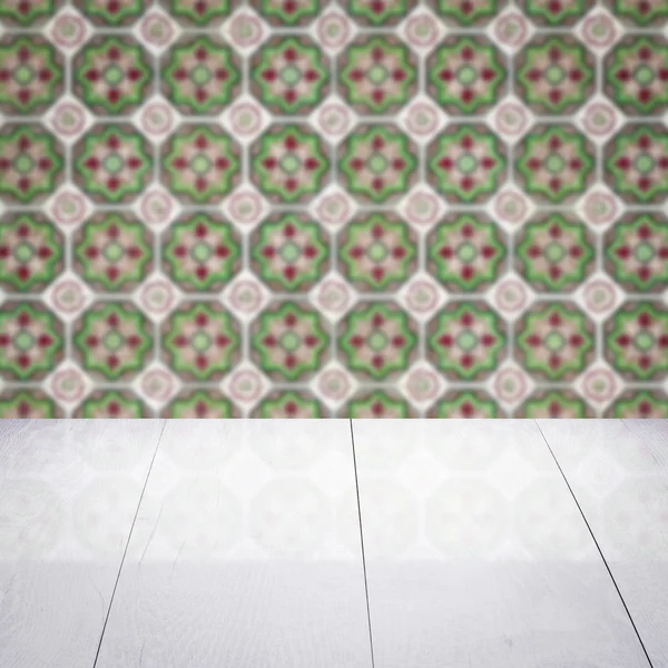 Wood table top and blur vintage ceramic tile pattern wall — Stock Photo, Image