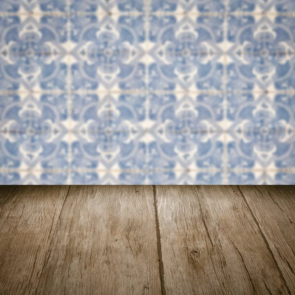 Wood table top and blur vintage ceramic tile pattern wall — Stock Photo, Image