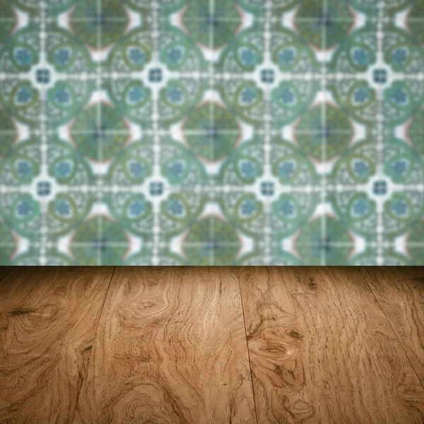 Wood table top and blur vintage ceramic tile pattern wall — Stock Photo, Image