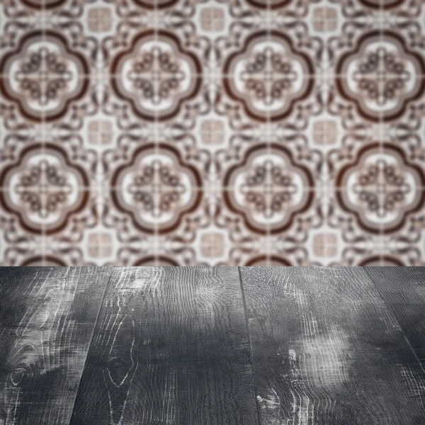 Wood table top and blur vintage ceramic tile pattern wall — Stock Photo, Image