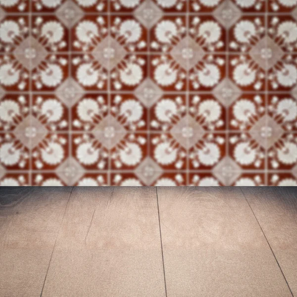 Wood table top and blur vintage ceramic tile pattern wall — Stock Photo, Image