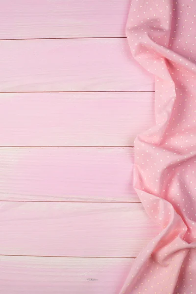 Pink towel over wooden table — Stock Photo, Image