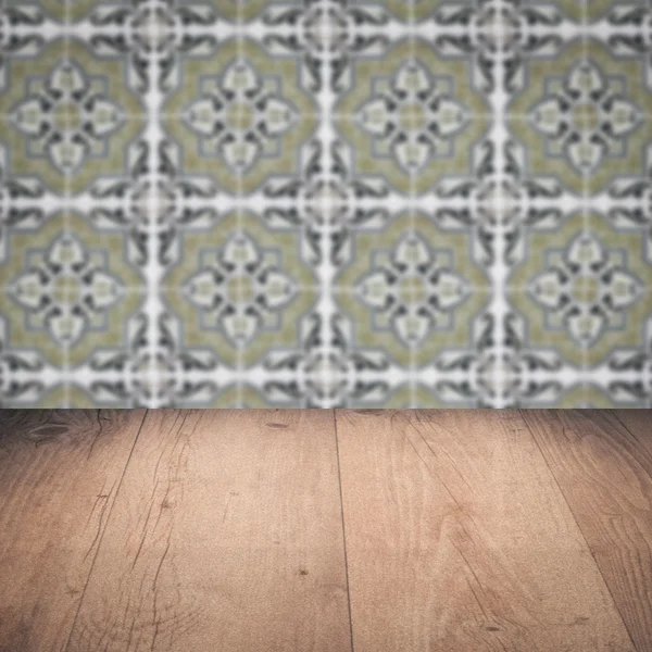 Wood table top and blur vintage ceramic tile pattern wall — Stock Photo, Image