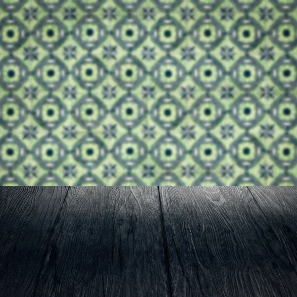 Wood table top and blur vintage ceramic tile pattern wall — Stock Photo, Image