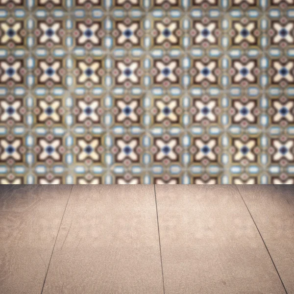 Wood table top and blur vintage ceramic tile pattern wall — Stock Photo, Image