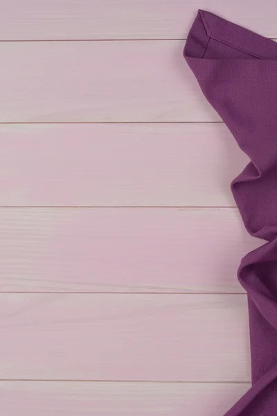 Purple towel over wooden table — Stock Photo, Image