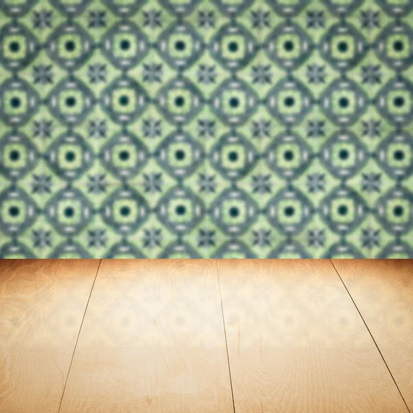 Wood table top and blur vintage ceramic tile pattern wall — Stock Photo, Image