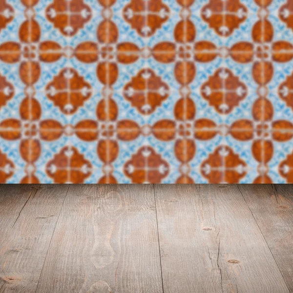 Wood table top and blur vintage ceramic tile pattern wall — Stock Photo, Image