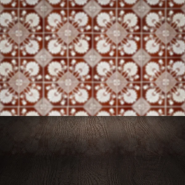 Wood table top and blur vintage ceramic tile pattern wall Royalty Free Stock Photos