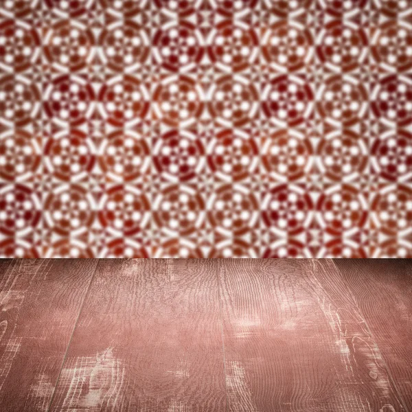 Wood table top and blur vintage ceramic tile pattern wall — Stock Photo, Image