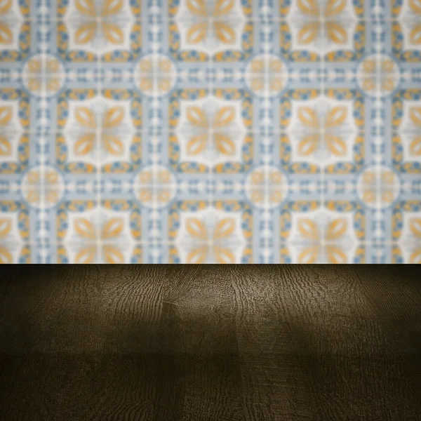 Wood table top and blur vintage ceramic tile pattern wall — Stock Photo, Image