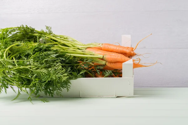 Carrots on wooden table — Stock Photo, Image