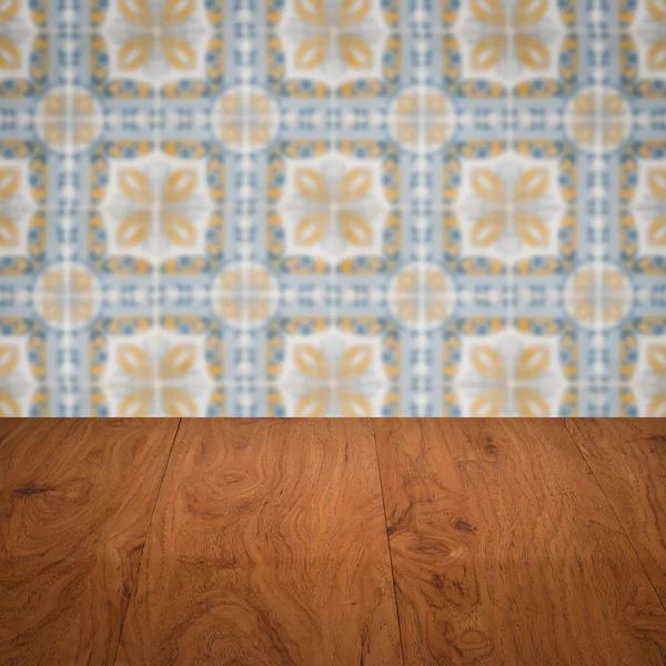 Wood table top and blur vintage ceramic tile pattern wall — Stock Photo, Image