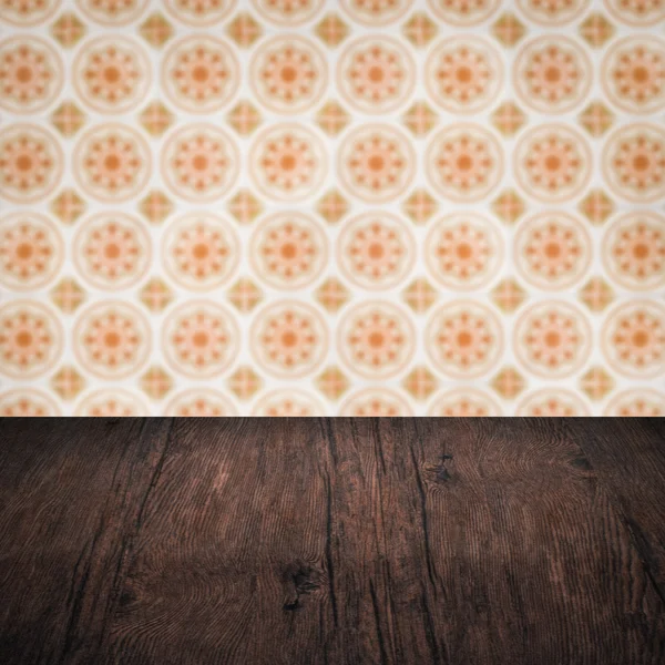 Wood table top and blur vintage ceramic tile pattern wall — Stock Photo, Image