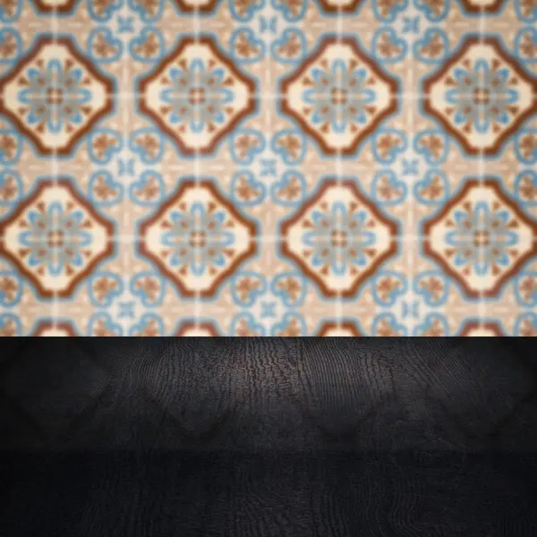 Wood table top and blur vintage ceramic tile pattern wall — Stock Photo, Image