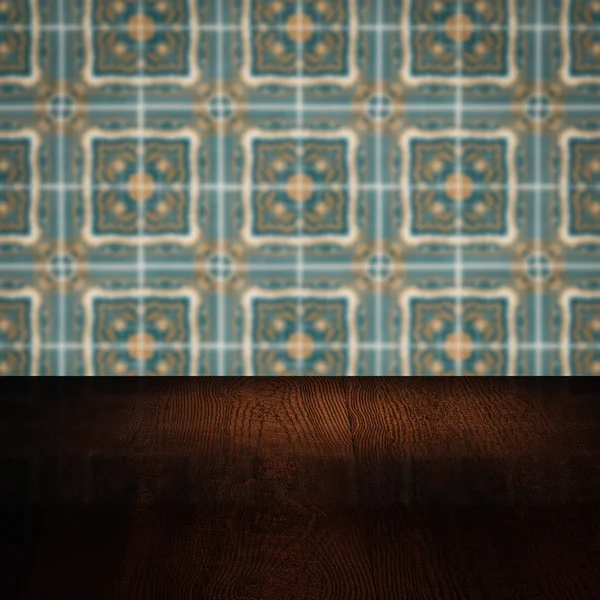 Wood table top and blur vintage ceramic tile pattern wall — Stock Photo, Image