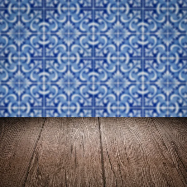 Wood table top and blur vintage ceramic tile pattern wall — Stock Photo, Image