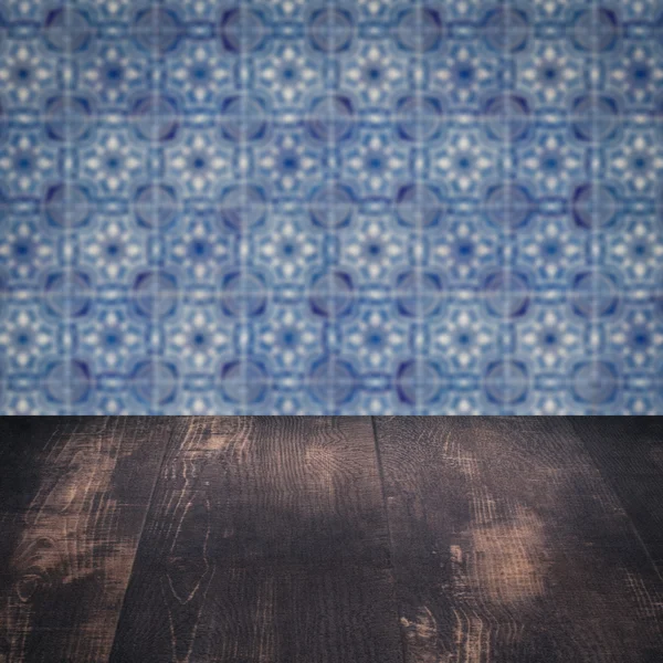 Wood table top and blur vintage ceramic tile pattern wall — Stock Photo, Image