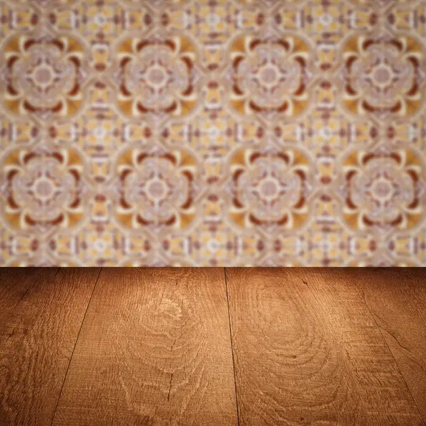 Wood table top and blur vintage ceramic tile pattern wall — Stock Photo, Image