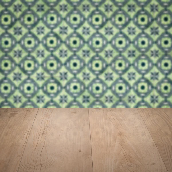 Wood table top and blur vintage ceramic tile pattern wall — Stock Photo, Image