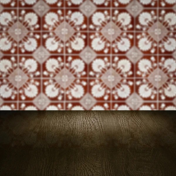 Wood table top and blur vintage ceramic tile pattern wall — Stock Photo, Image