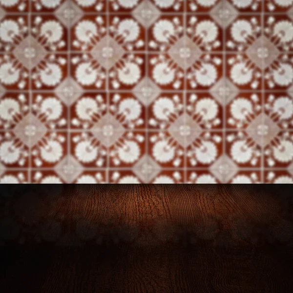 Wood table top and blur vintage ceramic tile pattern wall — Stock Photo, Image