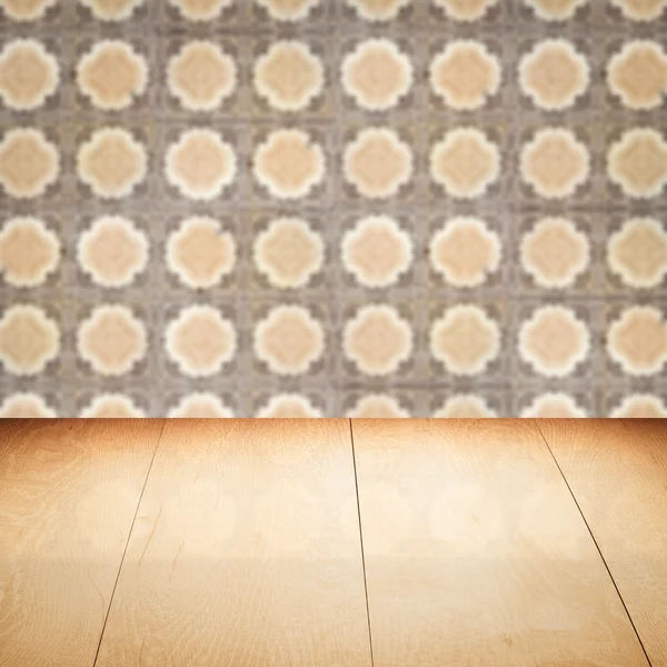 Wood table top and blur vintage ceramic tile pattern wall — Stock Photo, Image