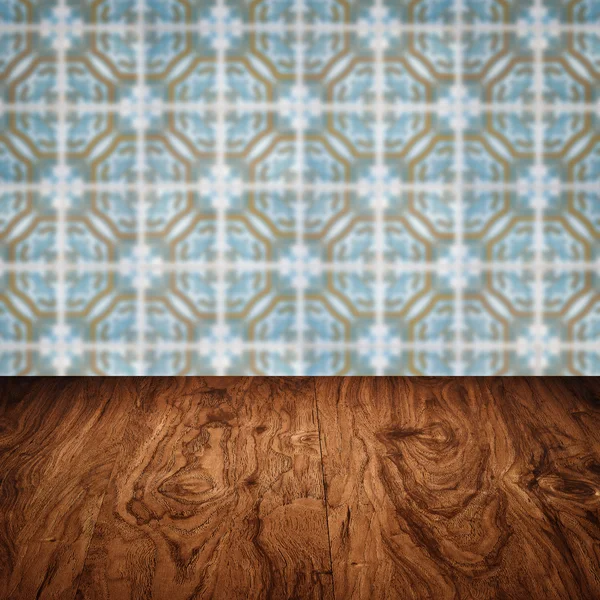 Wood table top and blur vintage ceramic tile pattern wall — Stock Photo, Image