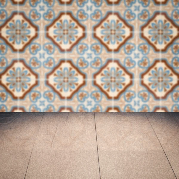 Wood table top and blur vintage ceramic tile pattern wall — Stock Photo, Image