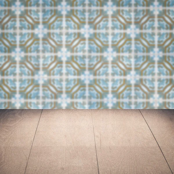 Wood table top and blur vintage ceramic tile pattern wall — Stock Photo, Image