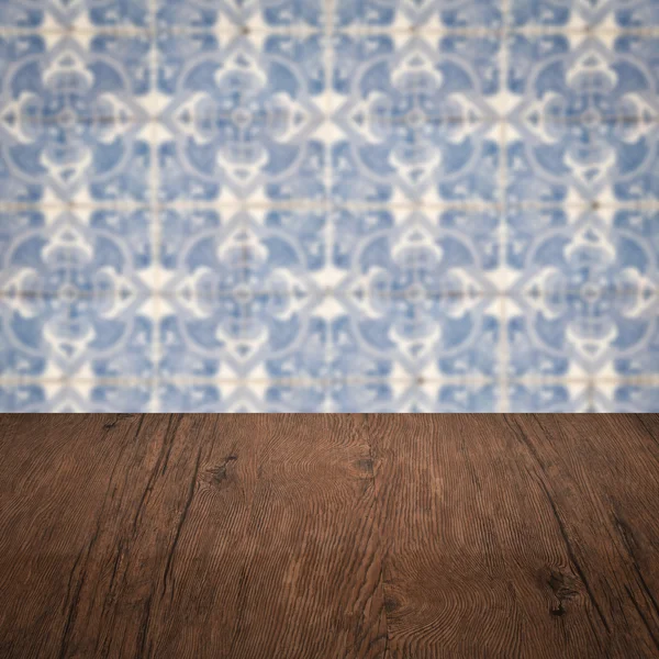 Wood table top and blur vintage ceramic tile pattern wall — Stock Photo, Image