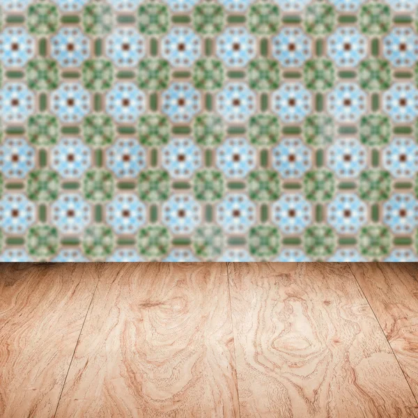 Wood table top and blur vintage ceramic tile pattern wall — Stock Photo, Image