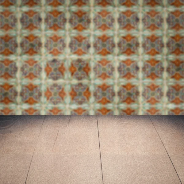 Wood table top and blur vintage ceramic tile pattern wall — Stock Photo, Image