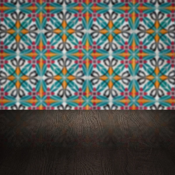 Wood table top and blur vintage ceramic tile pattern wall — Stock Photo, Image