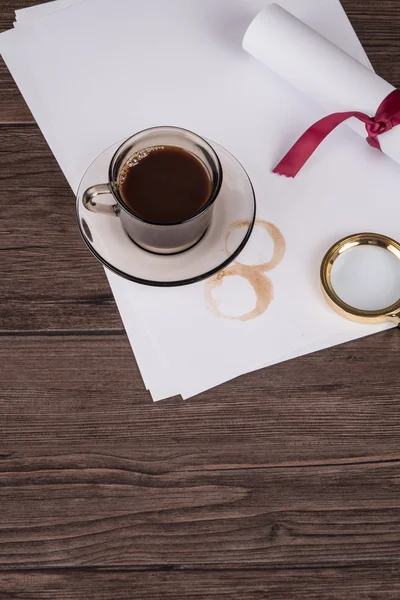 Coffee cup, paper sheets and detective hat — Stock Photo, Image