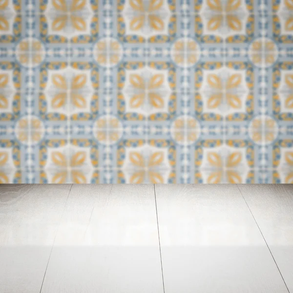 Wood table top and blur vintage ceramic tile pattern wall — Stock Photo, Image