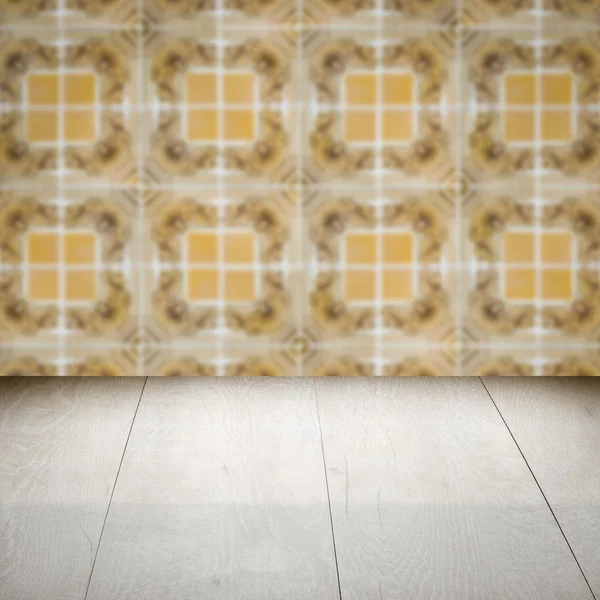 Wood table top and blur vintage ceramic tile pattern wall — Stock Photo, Image