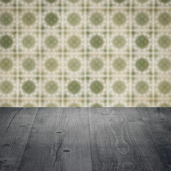 Wood table top and blur vintage ceramic tile pattern wall — Stock Photo, Image