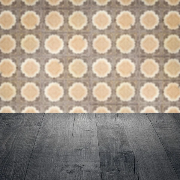 Wood table top and blur vintage ceramic tile pattern wall — Stock Photo, Image