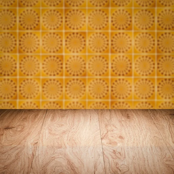 Wood table top and blur vintage ceramic tile pattern wall — Stock Photo, Image