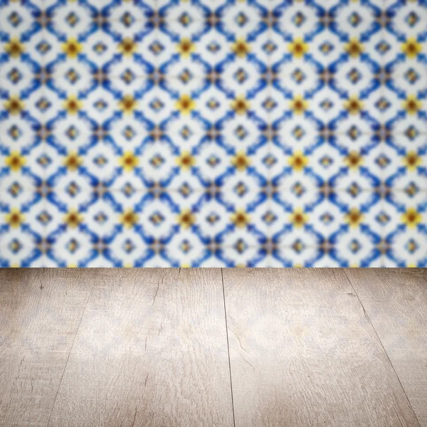 Wood table top and blur vintage ceramic tile pattern wall — Stock Photo, Image