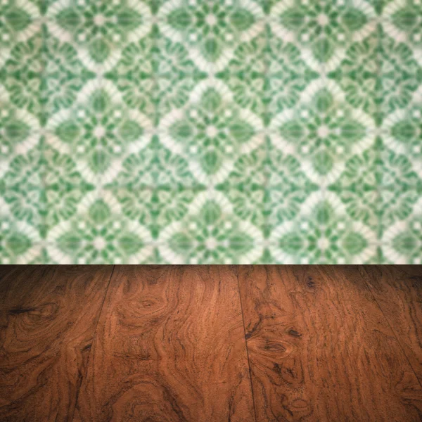 Wood table top and blur vintage ceramic tile pattern wall — Stock Photo, Image