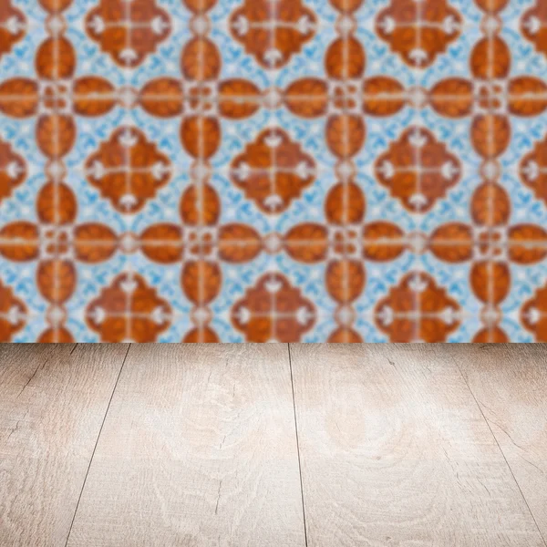 Wood table top and blur vintage ceramic tile pattern wall — Stock Photo, Image